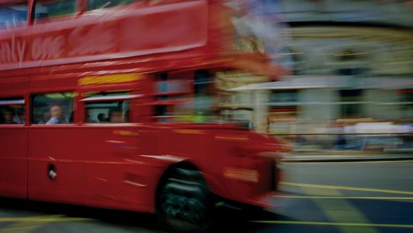 double decker bus zooms by in london