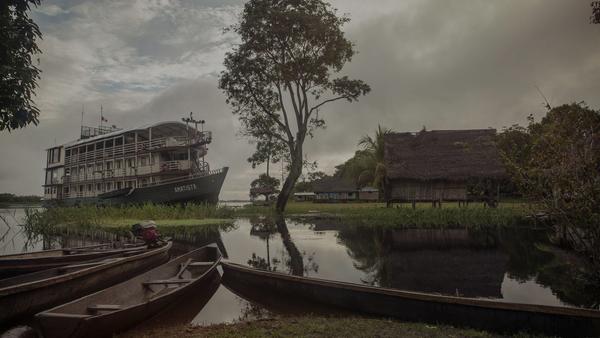 The Amatista boat and some local canoes in the foreground