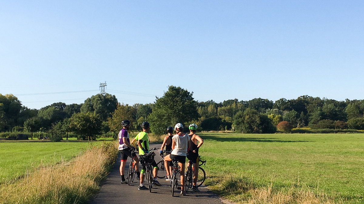 Our bicycling group collects in a field on the northern edge of where the Berlin Wall stood to ponder what it must have looked like 30 years before.