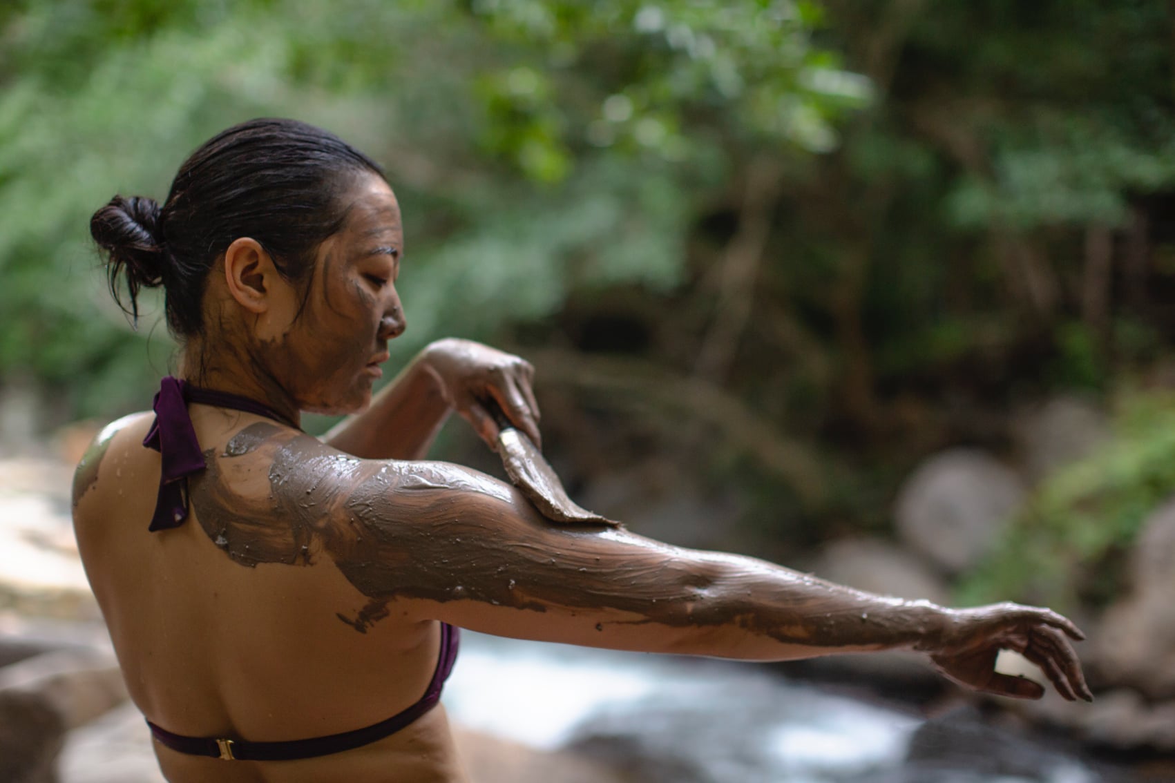 a travellers slathers on healing mud in costa rica