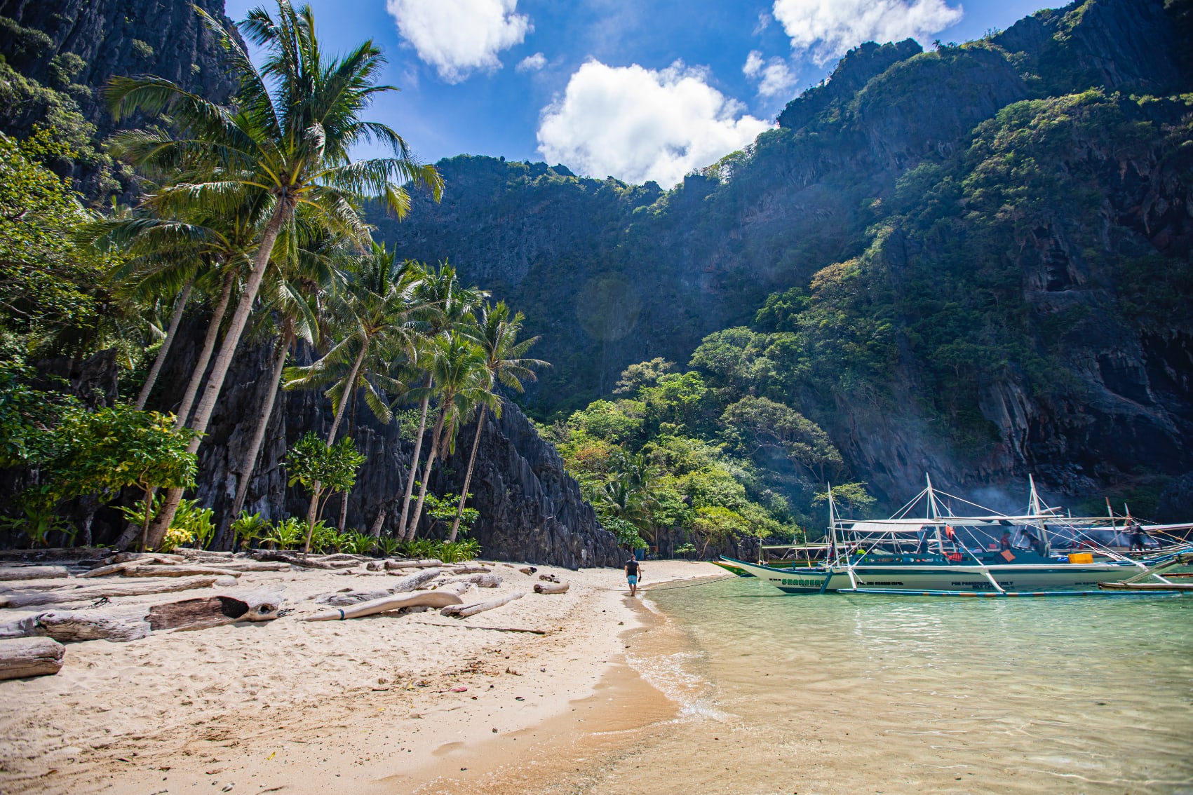 traditional boats bring travellers to the jungle-lined beaches of El Nido, Philippines