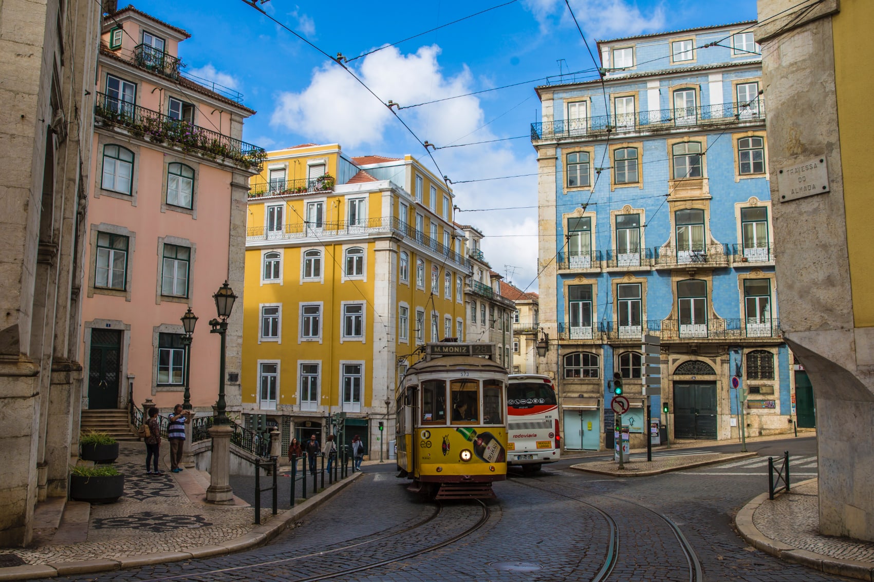 a traditional Lisbon tram travels along the city centre