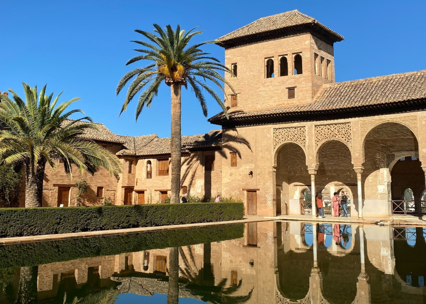 Interior look at reflective pool in an inner courtyard of the famed Alhambra fortress in Granada, Spain