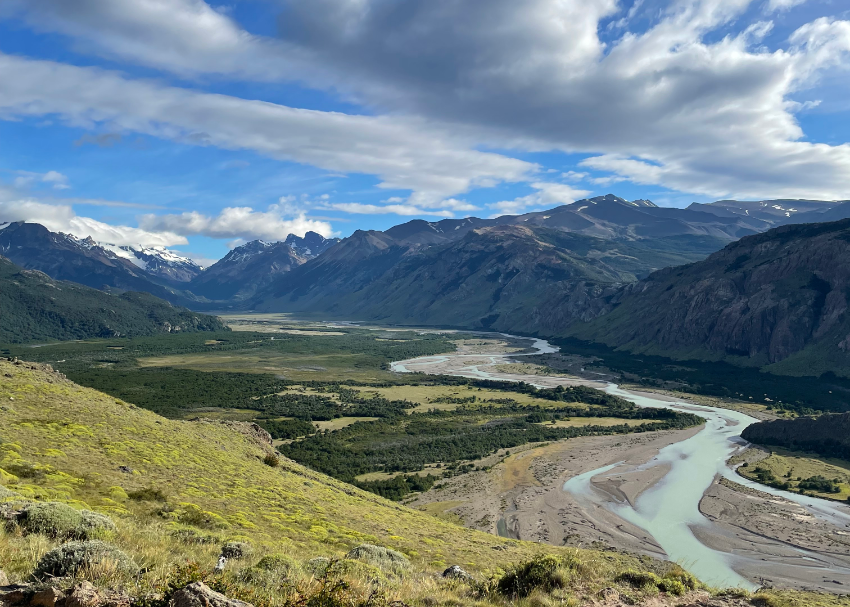 milky snakelike rivers meander through the valley with mighty Patagonian peaks on all sides