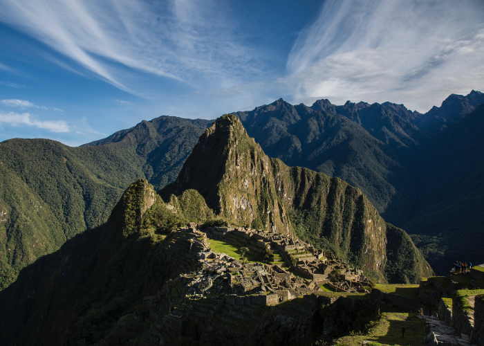 overlooking the famed citadel and mountain of Machu Picchu as the clouds drift softly on blue skies